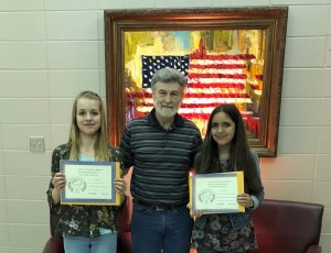 Beth Freudensprung (on left) - Junior Division - 2nd place-- and Naomi Morris (on right) - Junior Division - 2nd HM - receive their certificates and awards from Dennis Patton.