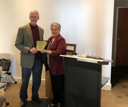 Merit Award - Mark Hotchkiss accepts PRA's Merit Award from Frieda Patton in honor of Karen Hayes.