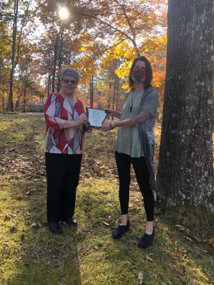 Frieda Patton, President (left), presents the 2020 Poets’ Roundtable of Arkansas Merit Award to Stacy Pendergrast (right)