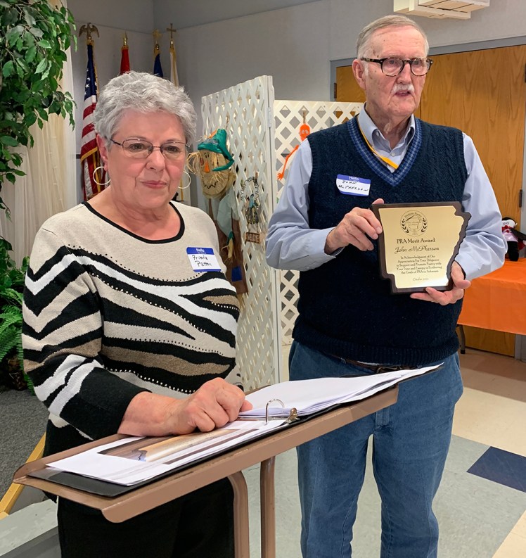 Frieda Patton presenting the Merit Award to John McPherson